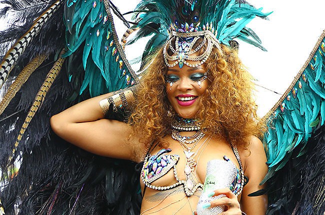 Rihanna is pictured on a truck partying with friends during the Kadooment parade in Barbados